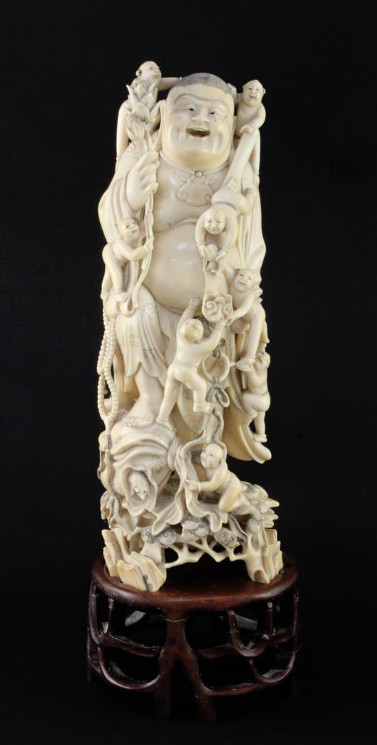 A large Chinese ivory group of Budai and attendant boys, early 20th century, 31.5cm, wood stand and fitted silk lined wood box